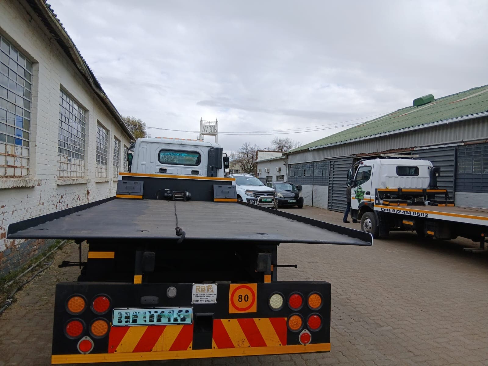 Rear view of a Bloem Towing flatbed truck