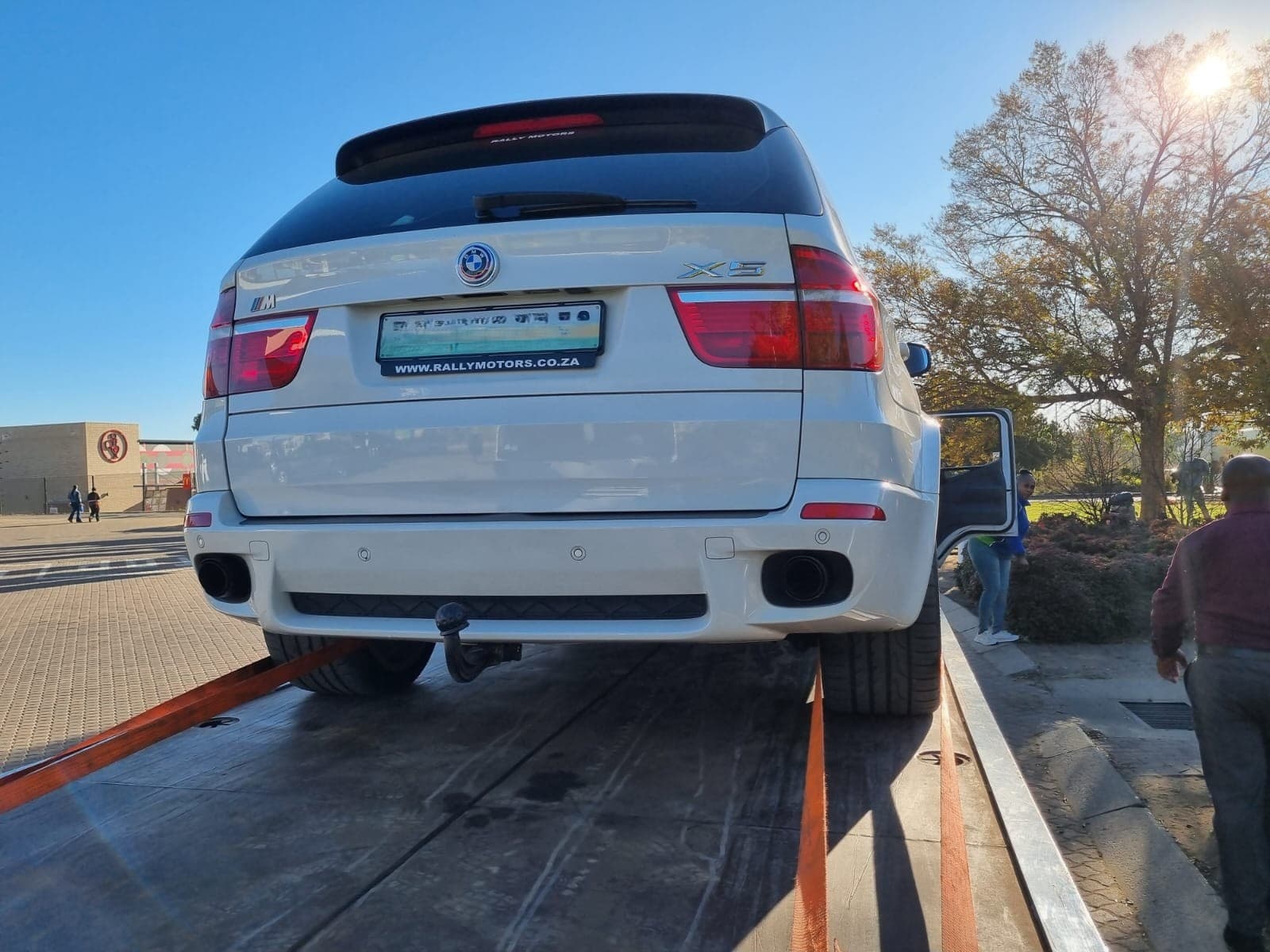 White SUV secured on a flatbed tow truck